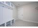 This mudroom features stylish patterned tile flooring and a convenient built-in storage bench with coat hooks at 555 Vine Pkwy, Pittsboro, NC 27312