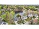 Stunning aerial view of a lakeside home surrounded by lush trees at 6209 Remington Lake Dr, Raleigh, NC 27616