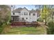 The backyard has multi-level decks with mature trees and a terraced lawn with stone walkways, and lots of beautiful plants at 6209 Remington Lake Dr, Raleigh, NC 27616