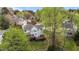 Aerial view of a lush backyard with mature trees, multi-level decks, and landscaped terraces at 6209 Remington Lake Dr, Raleigh, NC 27616