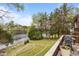 Beautiful backyard with a deck overlooking the lake, featuring well-maintained landscaping and a stone walkway at 6209 Remington Lake Dr, Raleigh, NC 27616