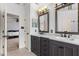 Bathroom features a double vanity with marble countertop, decorative mirrors, and tile flooring at 6209 Remington Lake Dr, Raleigh, NC 27616