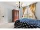 Comfortable bedroom with neutral tones, a window with natural light, stylish chandelier and a wooden armoire at 6209 Remington Lake Dr, Raleigh, NC 27616