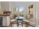 Bright breakfast nook with views of the lake, modern table and chairs, and updated cabinets at 6209 Remington Lake Dr, Raleigh, NC 27616