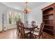 Bright dining area with a wood table, traditional chairs, and large windows overlooking the outdoors at 6209 Remington Lake Dr, Raleigh, NC 27616