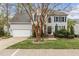 Charming two-story home with a well-manicured lawn, featuring a two-car garage and traditional architectural details at 6209 Remington Lake Dr, Raleigh, NC 27616