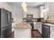 Well-lit kitchen with granite countertops, stainless steel appliances, and custom cabinetry at 6209 Remington Lake Dr, Raleigh, NC 27616