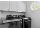 Modern laundry room with updated washer and dryer, and ample cabinet space at 6209 Remington Lake Dr, Raleigh, NC 27616