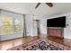 Living room features a view of the lake, hardwood flooring, and a large TV at 6209 Remington Lake Dr, Raleigh, NC 27616