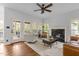 Spacious living room with fireplace, hardwood floors, and access to the outdoor deck at 6209 Remington Lake Dr, Raleigh, NC 27616