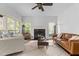 Bright living room with a fireplace, large windows and comfortable seating at 6209 Remington Lake Dr, Raleigh, NC 27616