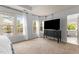 Spacious primary bedroom with a sitting area, large windows with lake views and an ensuite bathroom at 6209 Remington Lake Dr, Raleigh, NC 27616
