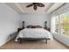 Bright primary bedroom boasting a tray ceiling, a spacious layout, and large windows offering a scenic view at 6209 Remington Lake Dr, Raleigh, NC 27616