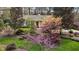Aerial view of home with mature trees, landscaped gardens, and inviting curb appeal at 6719 Falconbridge Rd, Chapel Hill, NC 27517
