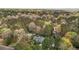 An aerial view of a charming home nestled in a lush forest setting surrounded by mature trees at 6719 Falconbridge Rd, Chapel Hill, NC 27517