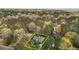 An aerial view of a charming home nestled in a lush forest setting surrounded by mature trees at 6719 Falconbridge Rd, Chapel Hill, NC 27517