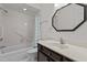 Clean bathroom featuring a tub, shower, and vanity with ample lighting at 6719 Falconbridge Rd, Chapel Hill, NC 27517