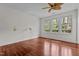 Inviting bedroom featuring hardwood floors, bright windows, and decorative wall lamps at 6719 Falconbridge Rd, Chapel Hill, NC 27517