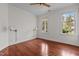 Comfortable bedroom with hardwood floors, ceiling fan, and two bright windows at 6719 Falconbridge Rd, Chapel Hill, NC 27517