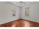 Bedroom with hardwood floors, natural light, and two windows showcasing the outdoors at 6719 Falconbridge Rd, Chapel Hill, NC 27517