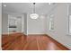 Bright dining room featuring hardwood floors, classic chandelier, and natural lighting at 6719 Falconbridge Rd, Chapel Hill, NC 27517