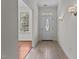 Entryway featuring tile flooring, sidelights, an overhead window, and paneled door at 6719 Falconbridge Rd, Chapel Hill, NC 27517