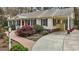 Lovely home with a charming brick walkway, carport, and well-manicured landscaping at 6719 Falconbridge Rd, Chapel Hill, NC 27517