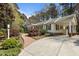 Beautifully landscaped home with a carport, red-brick walkway, and mature plantings at 6719 Falconbridge Rd, Chapel Hill, NC 27517