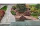 Well-manicured front yard featuring colorful landscaping, mature trees, and brick walkway to the front door at 6719 Falconbridge Rd, Chapel Hill, NC 27517