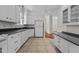 Bright kitchen with tile flooring, white cabinets, and ample countertop space at 6719 Falconbridge Rd, Chapel Hill, NC 27517
