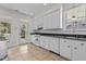 Well-equipped kitchen with tile floors, white appliances, and convenient backyard access at 6719 Falconbridge Rd, Chapel Hill, NC 27517