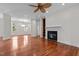 Open living space with wood floors, fireplace, and natural light from the windows at 6719 Falconbridge Rd, Chapel Hill, NC 27517