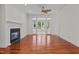 Spacious living room with a fireplace, wood floors, and access to an enclosed porch at 6719 Falconbridge Rd, Chapel Hill, NC 27517