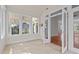 Bright sunroom with tile flooring and multiple windows offering outdoor views at 6719 Falconbridge Rd, Chapel Hill, NC 27517