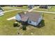 Aerial view of a home featuring a landscaped backyard with a screened porch and fire pit at 676 Wall Rd, Wendell, NC 27591