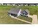 Expansive aerial view of a well-maintained home with a large yard and inviting front porch at 676 Wall Rd, Wendell, NC 27591