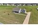 Aerial view of a landscaped property with a long driveway in a residential neighborhood at 676 Wall Rd, Wendell, NC 27591