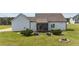 The landscaped backyard includes a screened porch, garden beds, and fire pit at 676 Wall Rd, Wendell, NC 27591