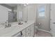 Bright bathroom featuring double vanity, large mirror, and a walk-in shower with tile surround at 676 Wall Rd, Wendell, NC 27591