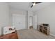 Spare bedroom featuring a ceiling fan, sewing machine, storage and access to a connecting room at 676 Wall Rd, Wendell, NC 27591
