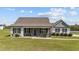 Charming single-story home featuring a welcoming porch, stone-accented posts, and beautiful landscaping at 676 Wall Rd, Wendell, NC 27591
