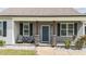 Inviting front porch with comfortable seating, stone accents, and a beautifully maintained walkway at 676 Wall Rd, Wendell, NC 27591