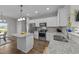Well-lit kitchen featuring stainless steel appliances, granite countertops, and a center island at 676 Wall Rd, Wendell, NC 27591