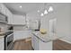 Bright kitchen with granite countertops, white cabinetry, and a functional center island at 676 Wall Rd, Wendell, NC 27591