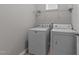 Bright laundry room with full size washer and dryer and overhead storage at 676 Wall Rd, Wendell, NC 27591