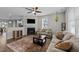 Bright, open living room with hardwood floors, fireplace, and seamless flow to other spaces at 676 Wall Rd, Wendell, NC 27591