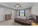 Cozy main bedroom with tray ceiling, carpet, and large windows overlooking the backyard at 676 Wall Rd, Wendell, NC 27591