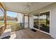 Relaxing screened porch with wood flooring, ceiling fan, and outdoor seating at 676 Wall Rd, Wendell, NC 27591