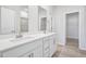 Bright bathroom with modern double vanity sinks, quartz countertops and hardwood floors at 700 Deschutes Dr, Garner, NC 27529