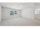 Spacious, light-filled bedroom with plush carpeting and a view of the neighborhood through the windows at 700 Deschutes Dr, Garner, NC 27529